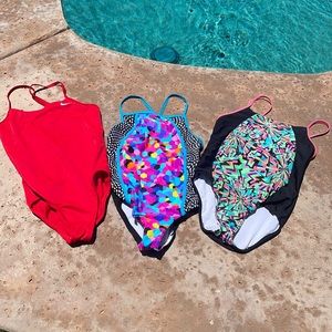 3 swimsuits (2 Speedo, 1 Nike). Nike is solid red